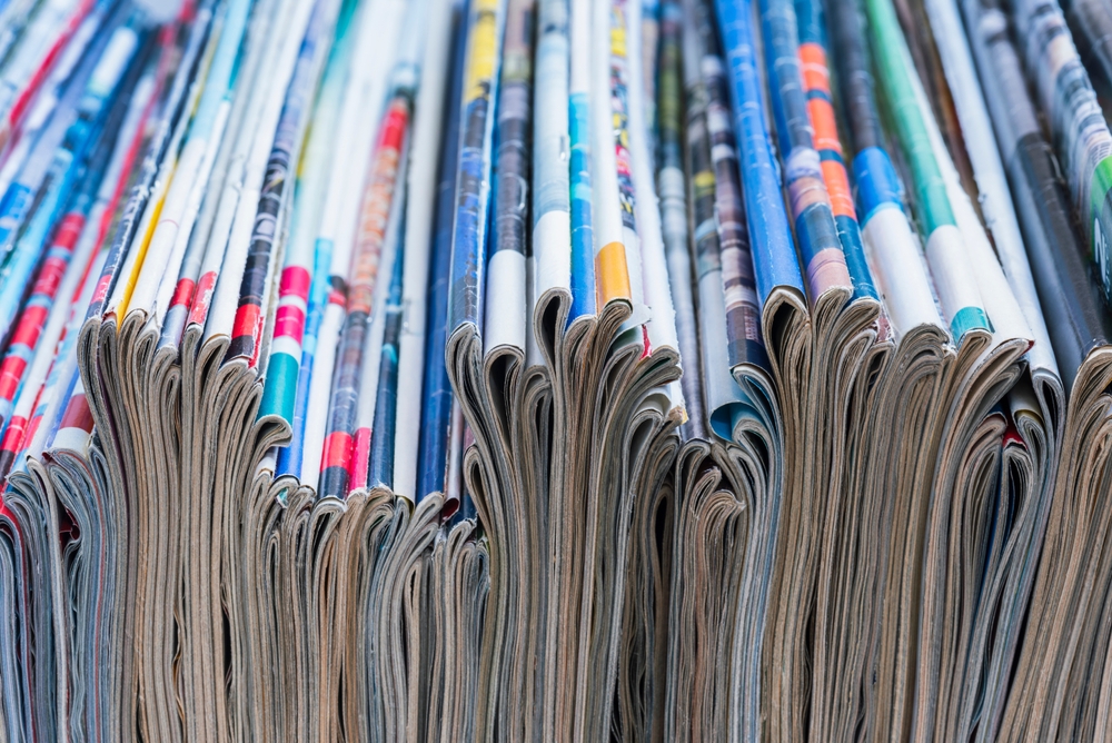 A cluttered row of old magazines.