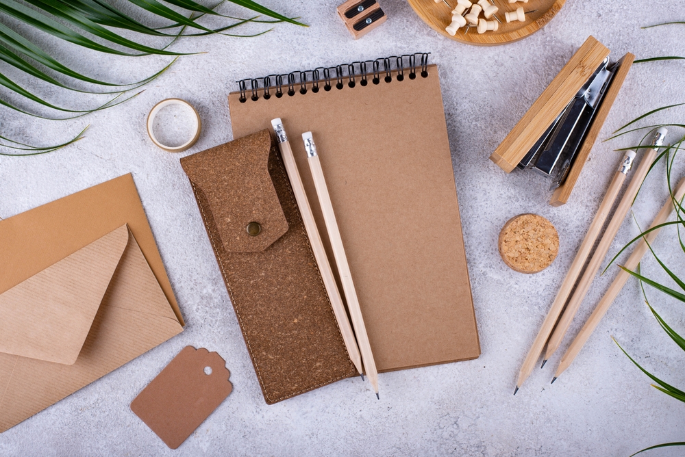 An image of a notebook, envelopes, pencils, and other supplies made from recycled materials.