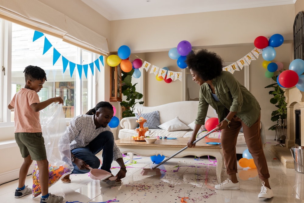 A family cleaning after their son's birthday party.