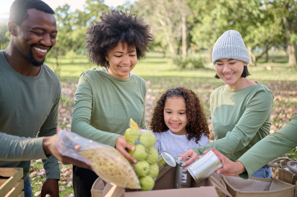 Volunteers putting food donations into a box.