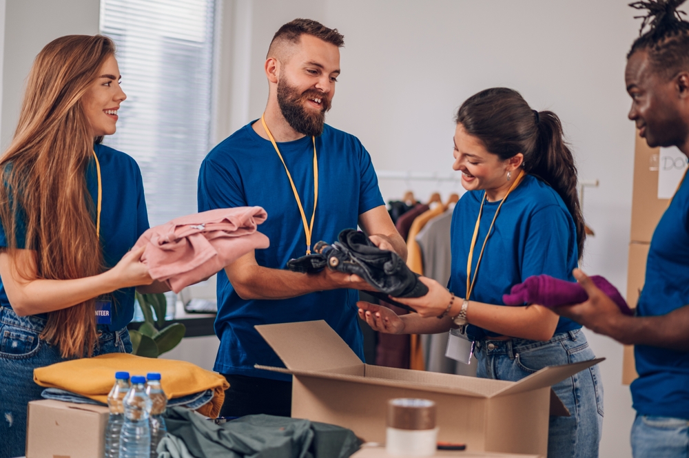 A group of volunteers packing clothing donations.
