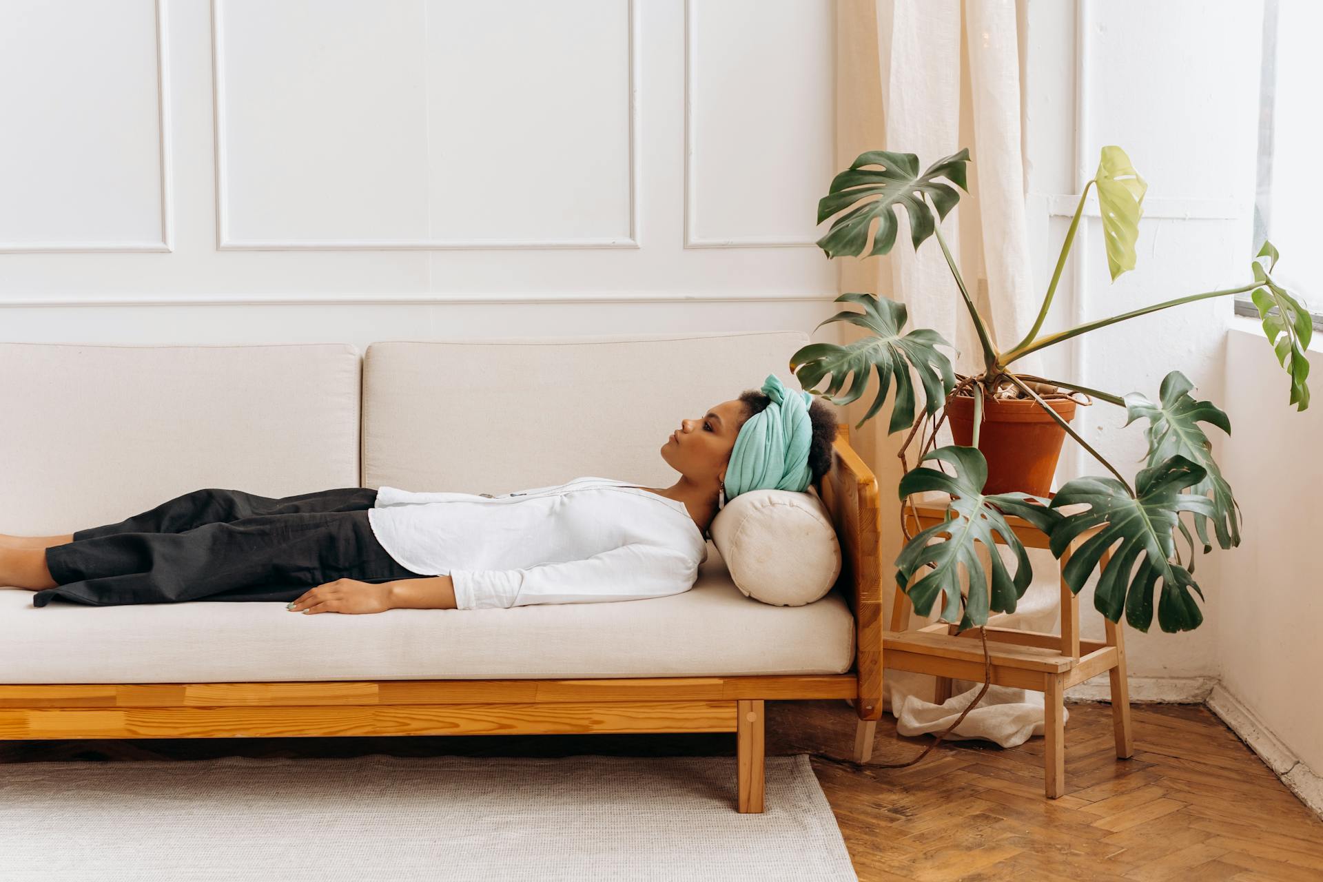 An image of a woman lying down resting on a couch.