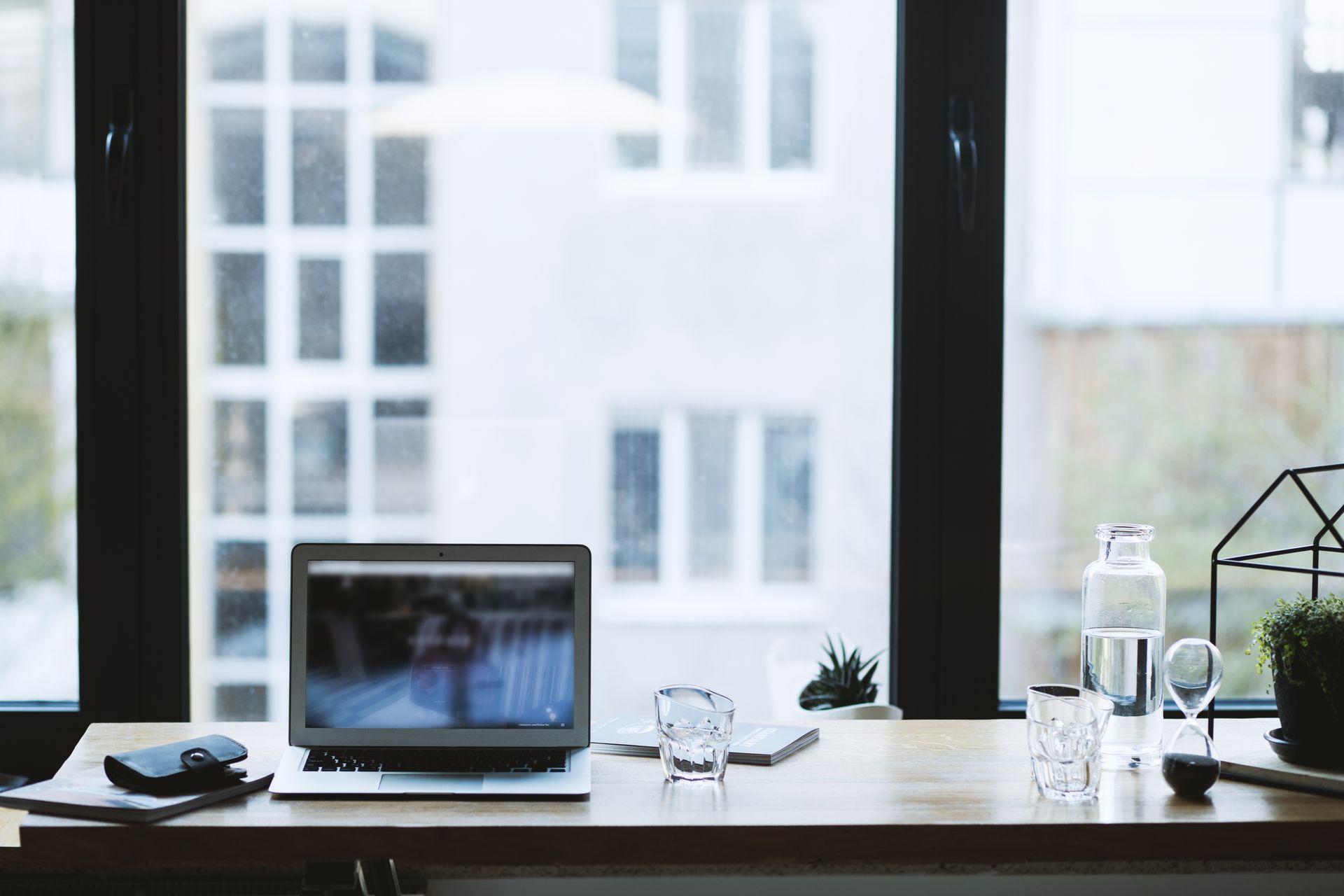 An image of a modern office workspace looking out towards a window.