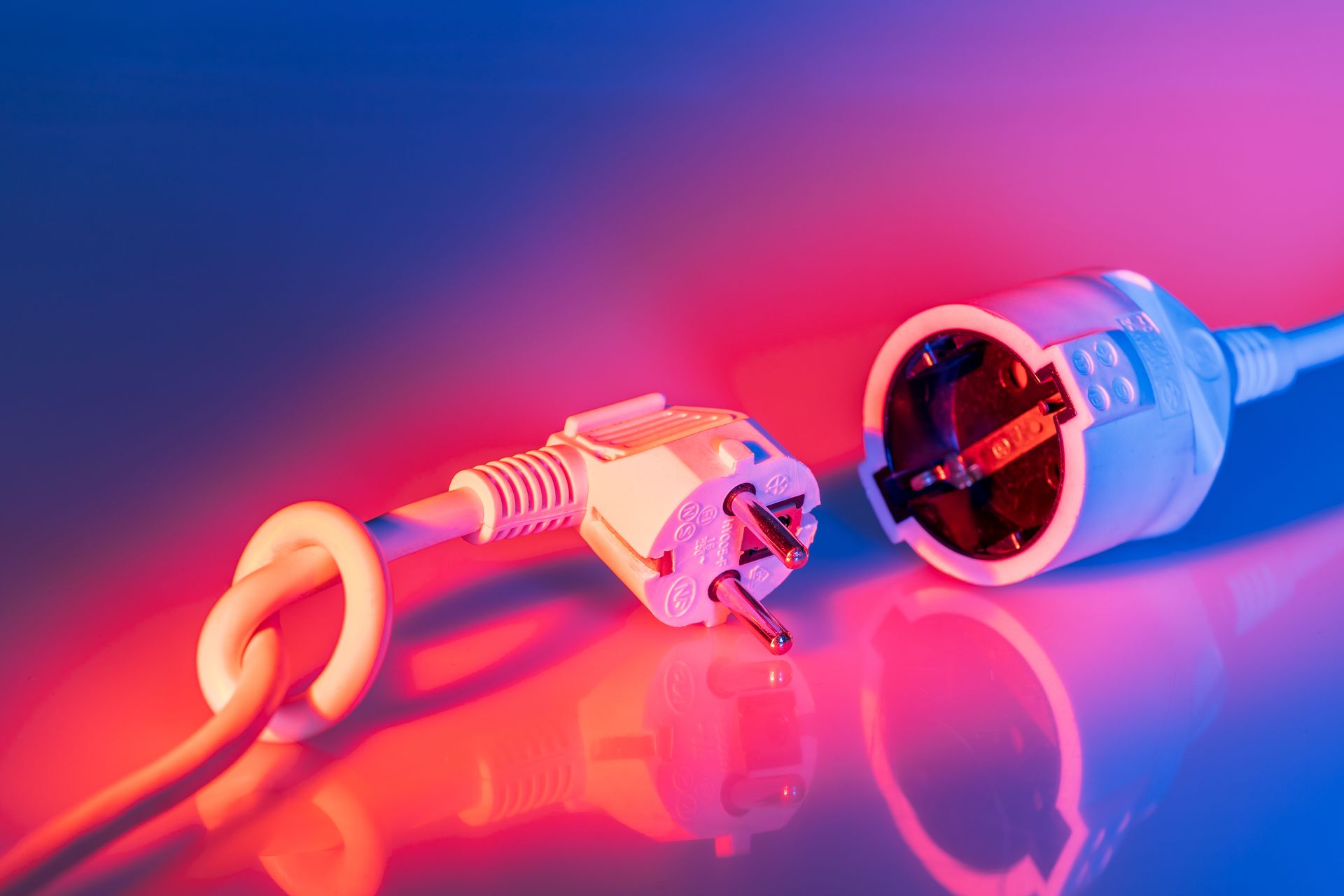 An image of an electrical plug with dramatic lighting.